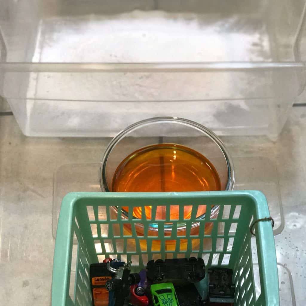 This simple science experiment combines baking soda and vinegar with pretend play, perfect for toddlers! An erupting car wash engages all the senses.