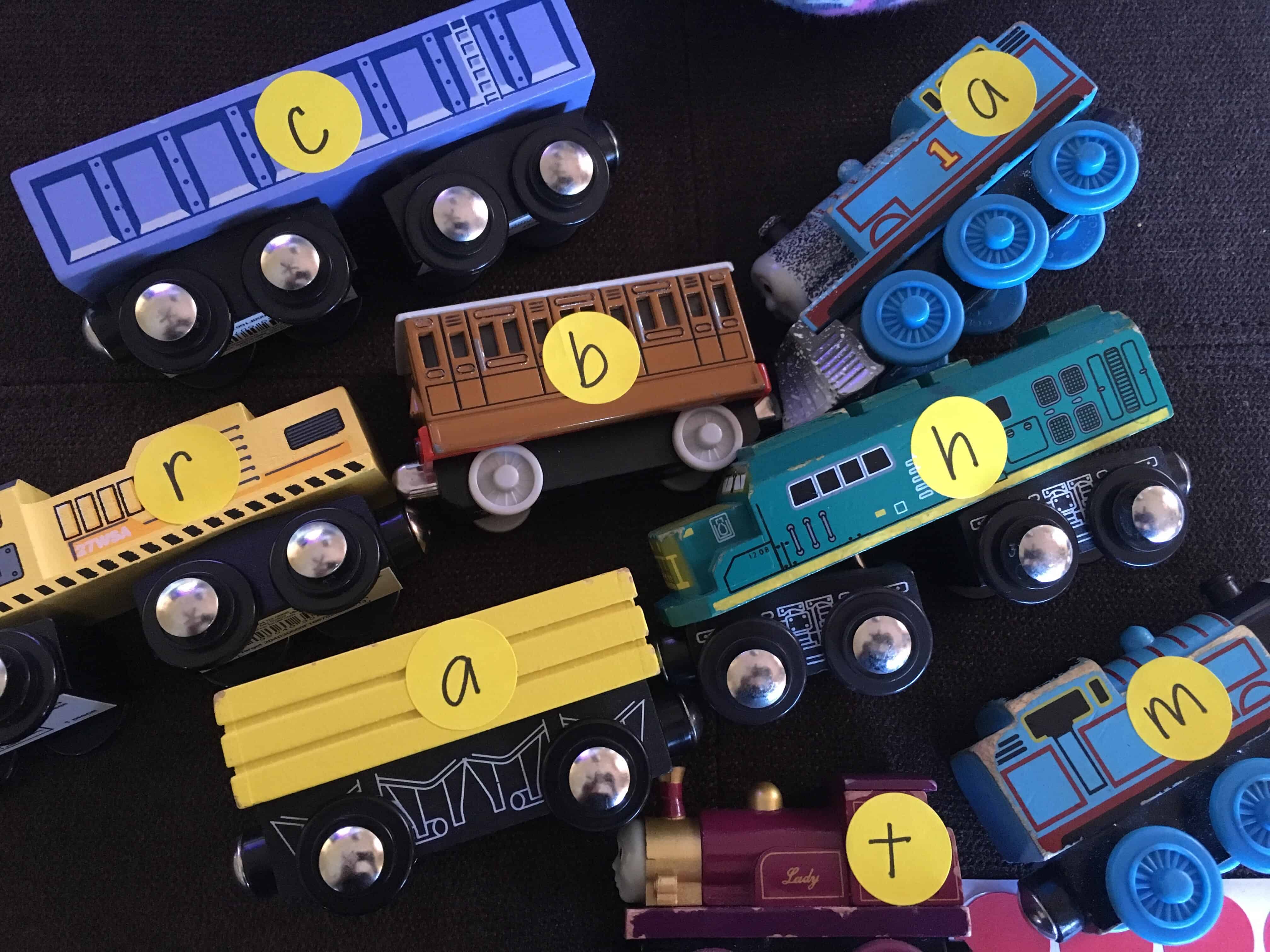 Learn to spell by making literacy fun through play! Use stickers on toy trains to create sight words. 