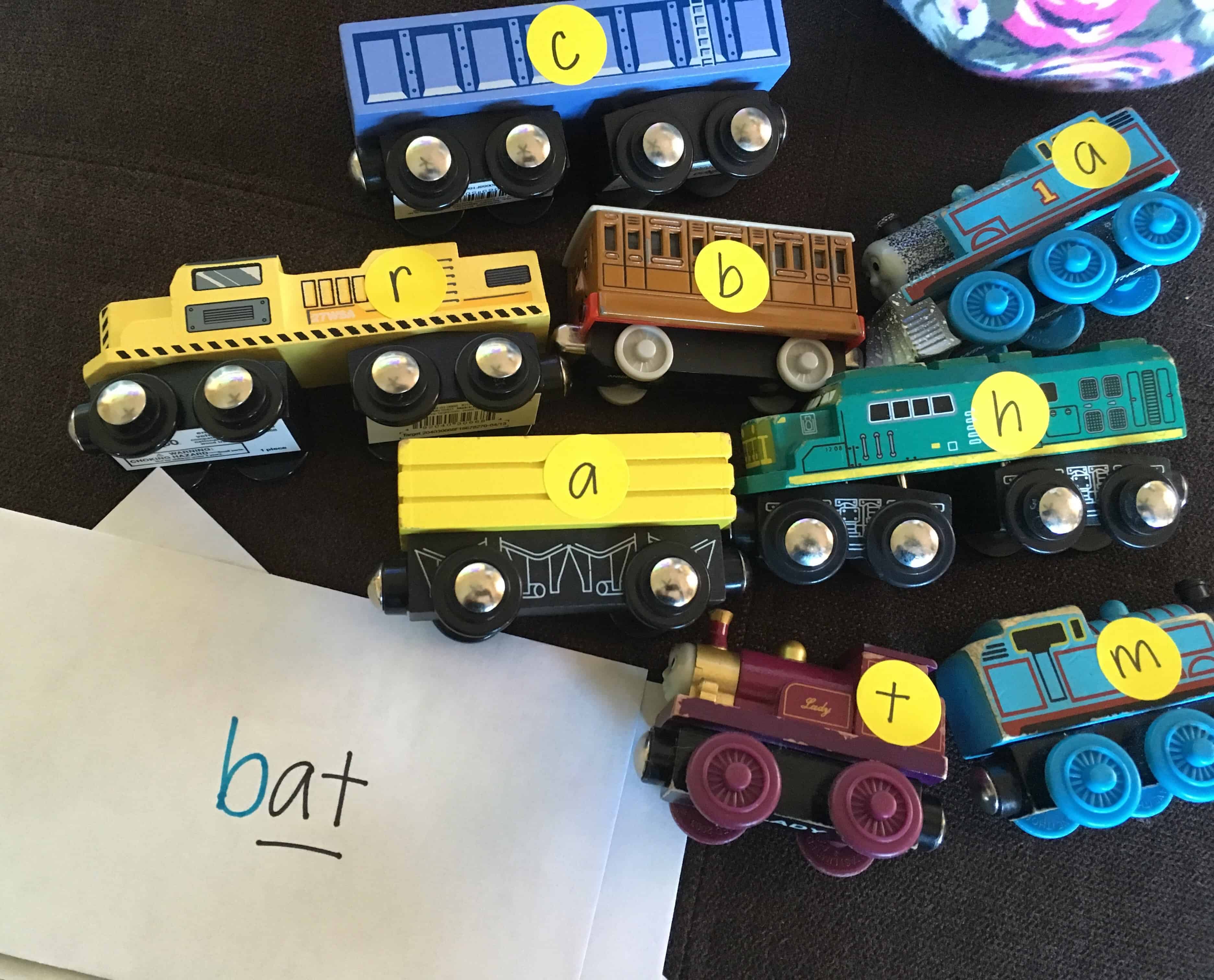 Learn to spell by making literacy fun through play! Use stickers on toy trains to create sight words. 