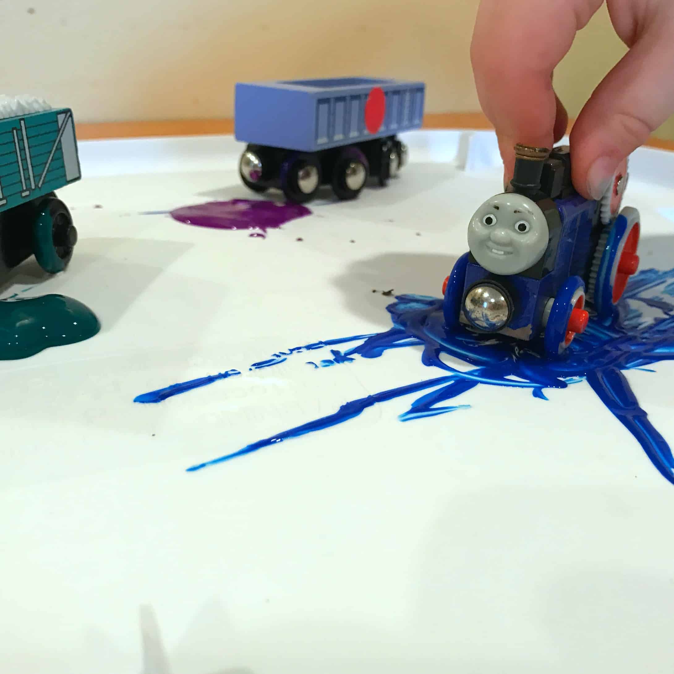 Painting with trains is a really great way to create a hands-on experience while learning colors! This fun method combines art with learning for toddlers.