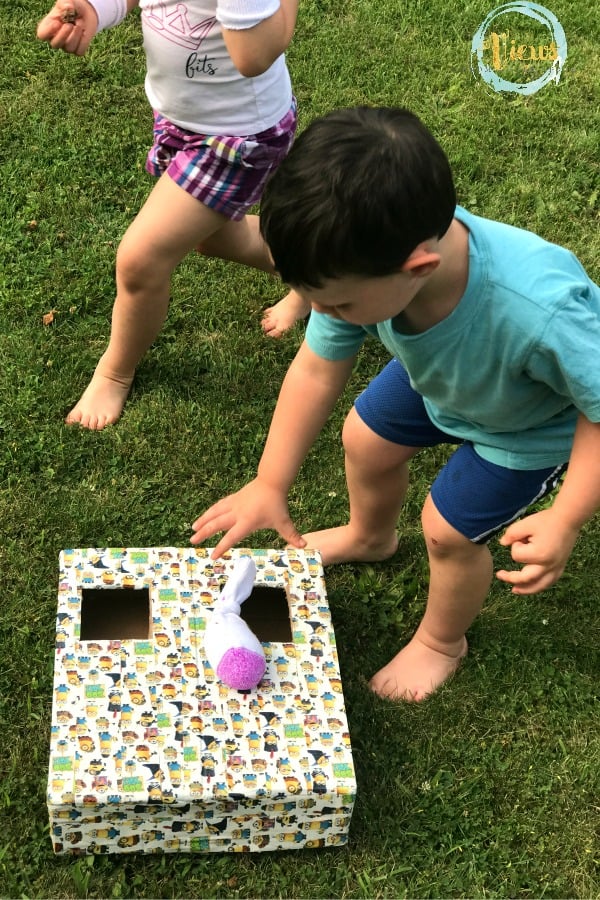 This DIY bean bag toss game is one of our favorite toddler playdate ideas. Even very young kids love to play in dry rice, and scooping and dumping is actually excellent for early learning!