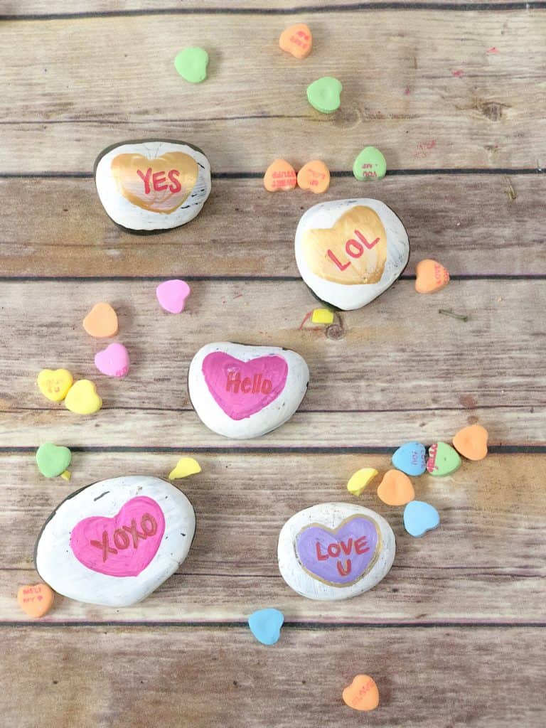 These conversation heart painted rocks take a spin on a classic Valentine's Day treat. Kids can play with or exchange these heart painted rocks!