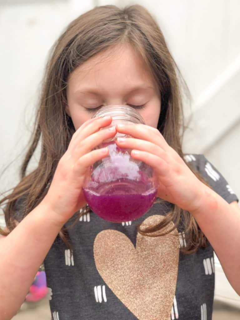 Turn Violet water made from freshly-picked flowers into Violet lemonade in this fun color-changing science experiment for kids. It's tasty too! #kidsactivities #stemathome #violetlemonade #natureactivities #homeschool