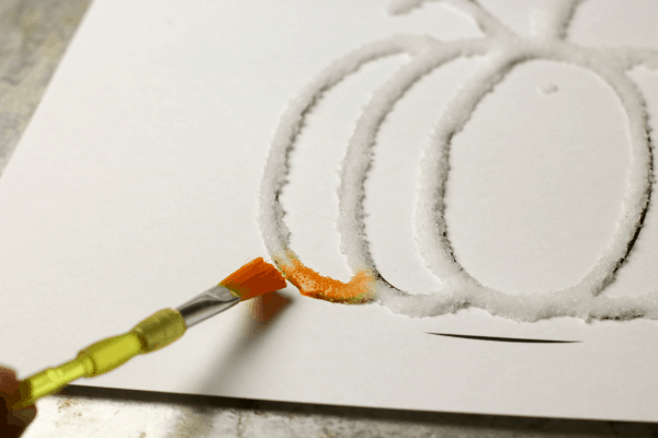 orange watercolor painted on salt